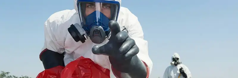 sewage clean up technician wearing protective gear handling biohazard materials in Tacoma, WA